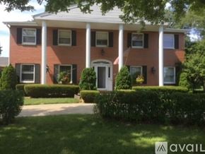 Mount Pleasant house for rent - A red brick house with a white door and windows.