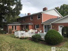 Mount Pleasant house for rent - A red brick house with a white picket fence.