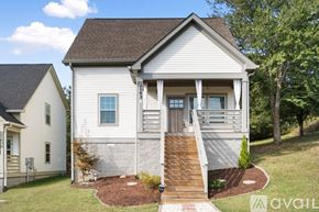 Ashland City apartment for rent - A two-story house with a front porch and a brown roof.