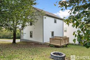 Ashland City apartment for rent - A white house with a wooden deck and a tree in front.