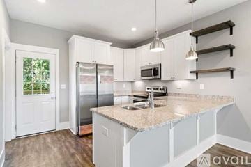 Ashland City apartment for rent - A kitchen with white cabinets and a granite countertop.