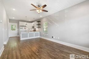 Ashland City apartment for rent - A spacious room with a ceiling fan and wooden flooring.