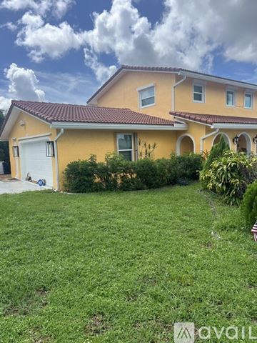 Coconut Creek house for rent - A kitchen with a table and chairs and a painting on the wall.
