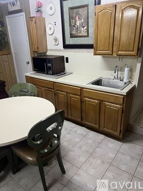 Coconut Creek house for rent - A wooden cabinet with glass doors and drawers.