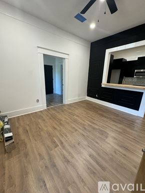 Greenville condo for rent - A room with wooden flooring and a ceiling fan.