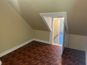 Alton house for rent - A room with a wooden floor and a white door.