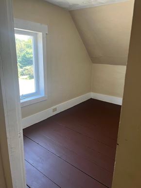 Alton house for rent - A room with a window and wooden flooring.