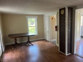 Alton house for rent - A room with a table and a window.