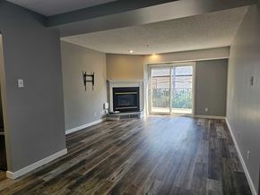 Edmonton apartment for rent - A living room with a fireplace and sliding glass doors.