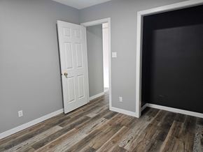 Edmonton apartment for rent - A room with a white door and a black wall.