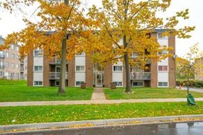Kitchener apartment for rent - Apartment building with trees in front of it.
