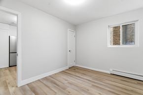 Kitchener apartment for rent - A room with a window and a wooden floor.