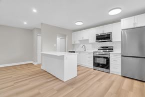 Waterloo apartment for rent - A modern kitchen with wooden floors and stainless steel appliances.