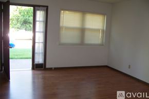 Pekin townhouse for rent - A room with a window and wooden floors is available for rent.