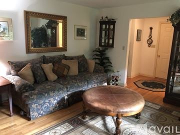 Woodbury house for rent - A living room with a blue patterned couch and a wooden coffee table.