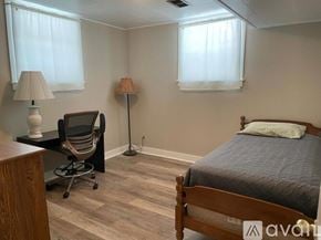 Rawlins apartment for rent - A bedroom with a bed, chair, and two lamps.