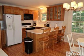 York apartment for rent - A kitchen with wooden cabinets and a white fridge.