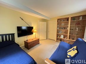 York apartment for rent - A bedroom with a bed, a chair, and a TV.