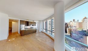 New York apartment for rent - A large open living space with wooden floors and a view of the city.