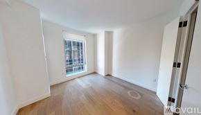 New York apartment for rent - A room with a window and wooden flooring.