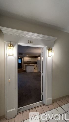 Louisville apartment for rent - A room with a doorway leading to another room with a number 104 on the wall.