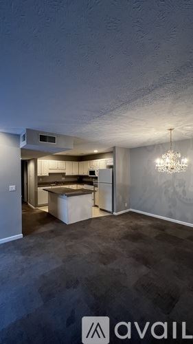 Louisville apartment for rent - A room with a kitchen area and a dining table.