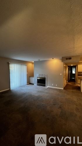 Louisville apartment for rent - A spacious living room with a fireplace and sliding glass doors.