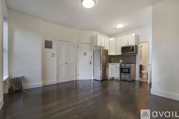 New York apartment for rent - A spacious kitchen with stainless steel appliances and a wooden floor.