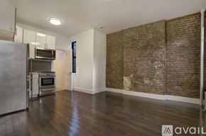 New York apartment for rent - A kitchen with a refrigerator, oven, and microwave.