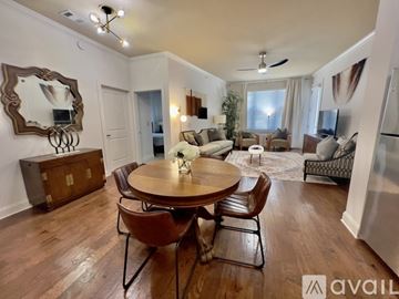 Knoxville condo for rent - A well-lit living room with a wooden dining table and chairs.