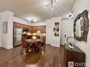 Knoxville condo for rent - A kitchen with a table and chairs in the middle of the room.
