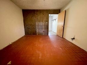 Jeffersonville house for rent - A room with a red tiled floor and a door on the right.