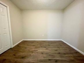 Jeffersonville house for rent - A room with a wooden floor and a white door.