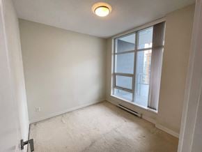 Burnaby apartment for rent - A room with a window and a carpeted floor.