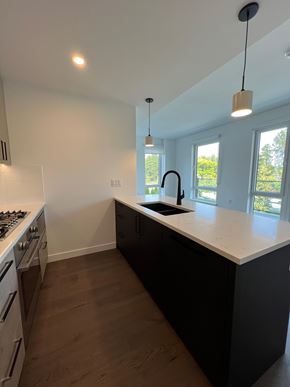 Vancouver apartment for rent - A kitchen with a black counter and a white stove.