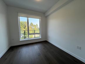 Vancouver apartment for rent - A room with a large window and wooden flooring.