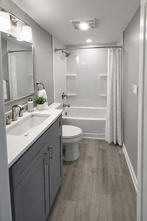 Wausau apartment for rent - A bathroom with a toilet, sink, and shower.