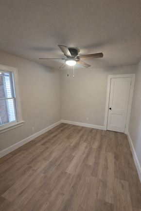 Wausau apartment for rent - A room with a ceiling fan and wooden flooring.