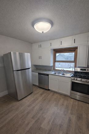 Wausau apartment for rent - A kitchen with a refrigerator, stove, and oven.