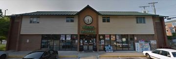 Muncie apartment for rent - A building with a clock on the front and the words "village" and "perry" written on it.
