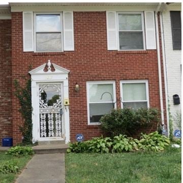 Louisville house for rent - A red brick house with a white door and windows.