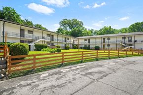 Atlanta apartment for rent - A row of apartment buildings with a wooden fence in front.