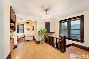 Spokane townhouse for rent - A living room with a white sofa and a wooden floor.