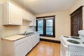Spokane townhouse for rent - A kitchen with white cabinets and a white stove top oven.