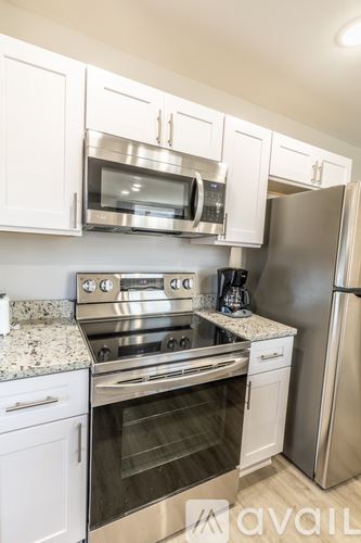 Charlottesville apartment for rent - A kitchen with white cabinets and stainless steel appliances.