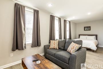 Charlottesville apartment for rent - A living room with a grey couch and a wooden coffee table.