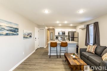 Charlottesville apartment for rent - A living room with a grey couch and a wooden coffee table.