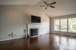 Durham house for rent - A living room with a fireplace and a flat screen TV mounted above it.