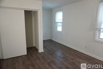 Dundalk apartment for rent - A kitchen with wooden cabinets and a black stove top oven.