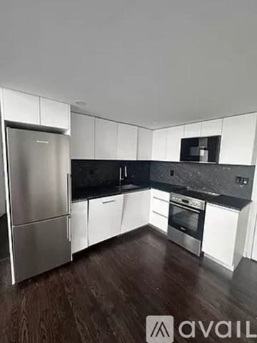 New York apartment for rent - A kitchen with a refrigerator, oven, and microwave.